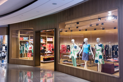 Boutique display window with mannequins in fashionable dresses